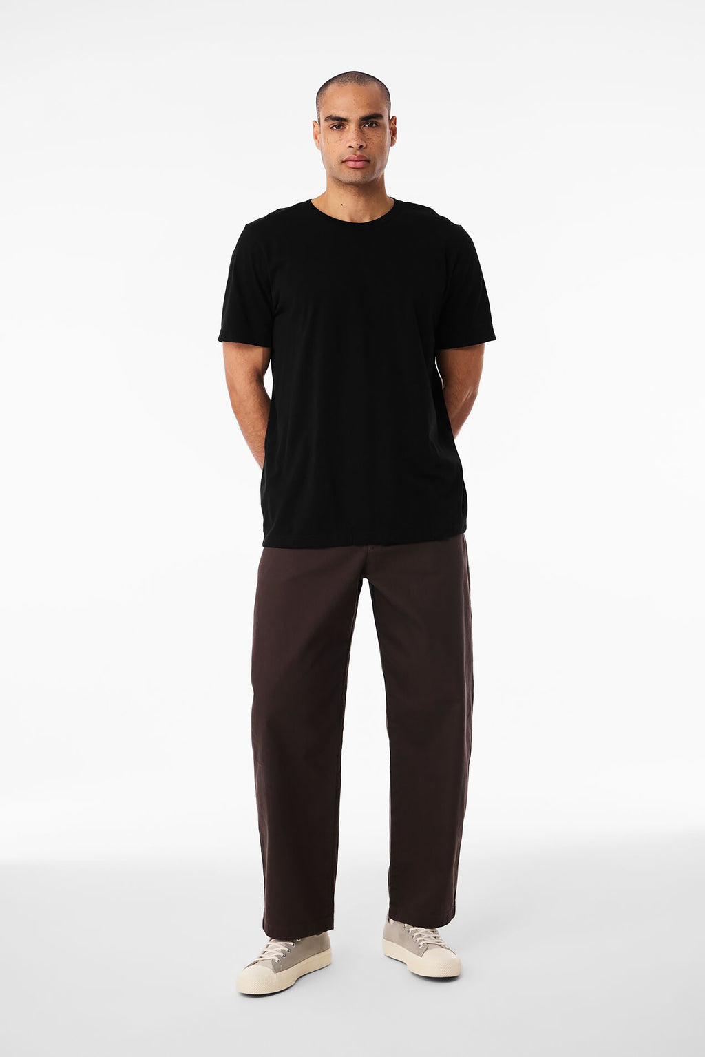 A man wearing the black Bella+Canvas 3001 t-shirt, seen from the front