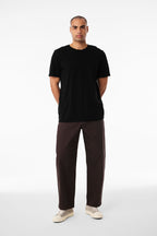 A man wearing the black Bella+Canvas 3001 t-shirt, seen from the front