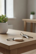The beech disc keyring on a hallway table beside a bunch of house keys