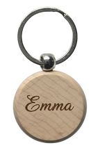 Example of the engraving: the beech wood keyring, circle, laser-engraved with a name in a flowing script