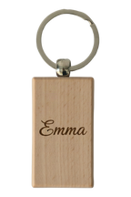 Example of the engraving: the beech wood keyring, rectangle, laser-engraved with a name in a flowing script