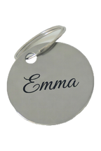 Example of the engraving: the stainless steel keyring, circle, laser-marked with a name in a flowing script, dark against the polished steel