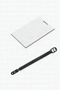 A blank white sublimation bag tag with its black strap beside it