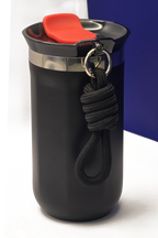The top of the cup close up, showing the polished steel collar, the red flap on the lid and the knotted carry rope
