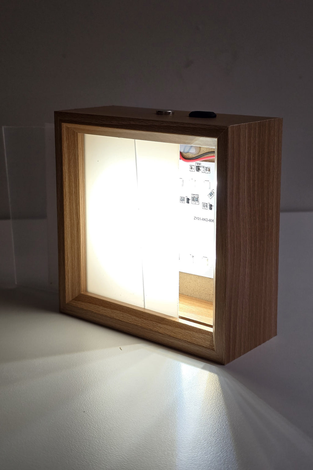 The 4 inch night light switched on with the front panel half slid out, showing the LEDs behind it