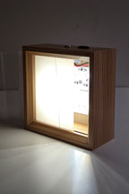 The 4 inch night light switched on with the front panel half slid out, showing the LEDs behind it