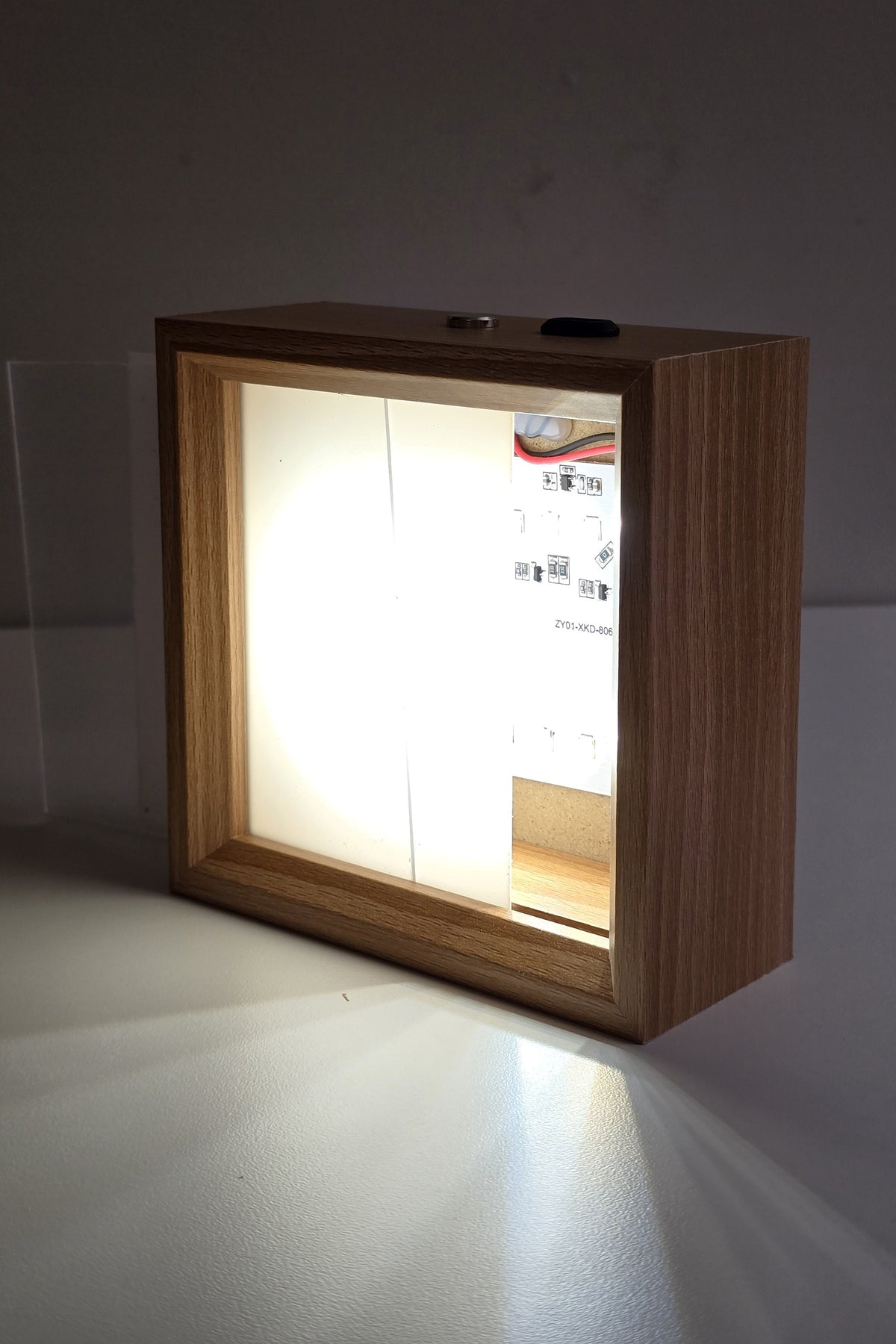 The 4 inch night light switched on with the front panel half slid out, showing the LEDs behind it