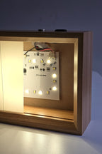 The 6 inch night light in warm white with the panel slid aside, showing the ring of warm and white LEDs on the board