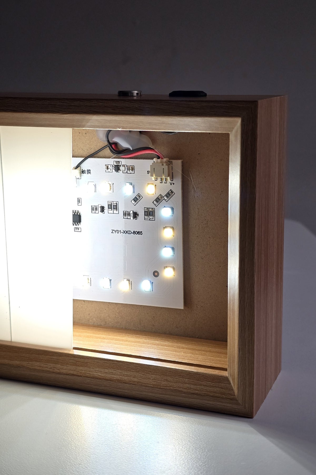The 6 inch night light in neutral white with the panel slid aside